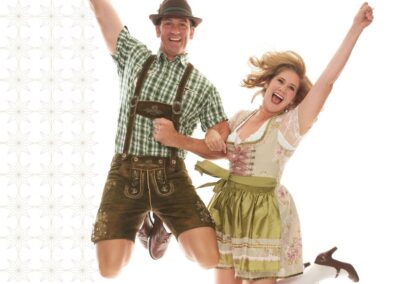 Man and woman dressed up in traditional lederhosen attire.